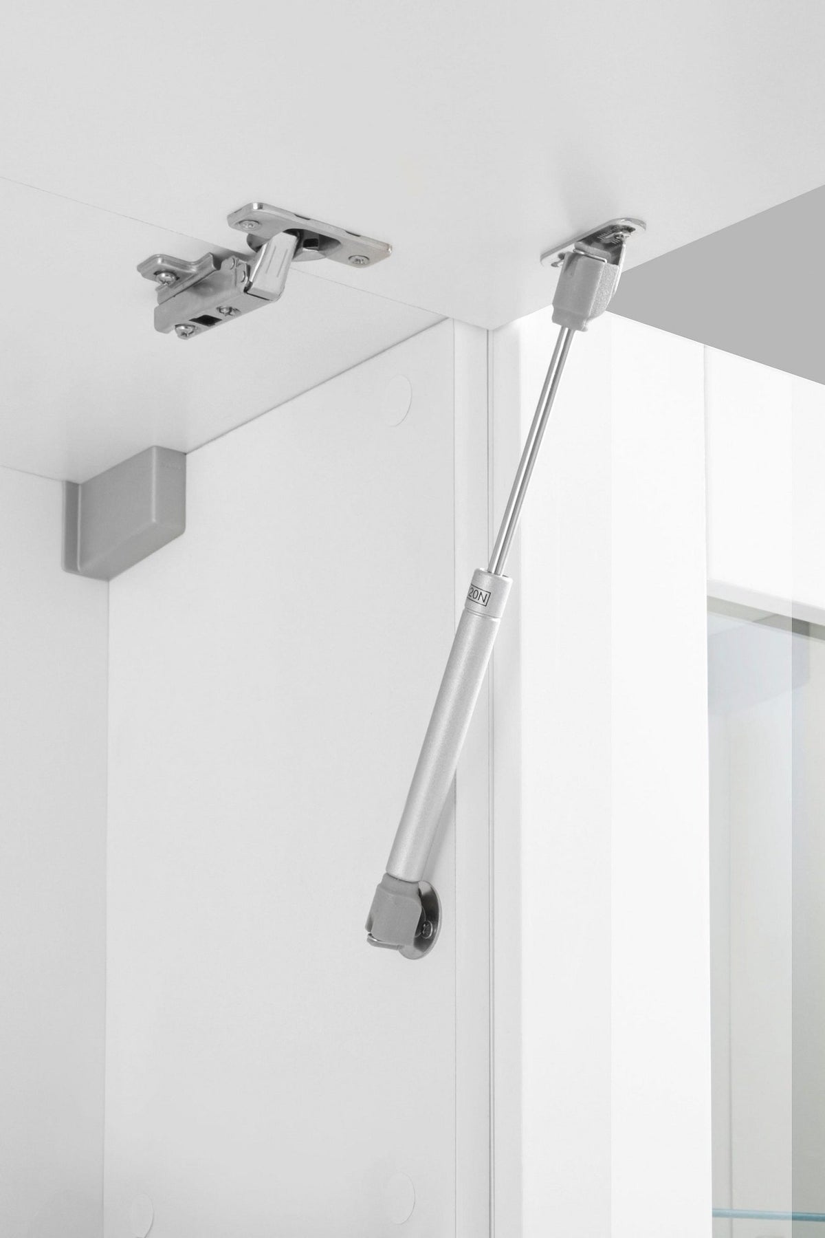 Dettaglio interno della parete ECHO bianco lucido con cerniera a libro e pistoncino a gas #colore_Bianco Lucido