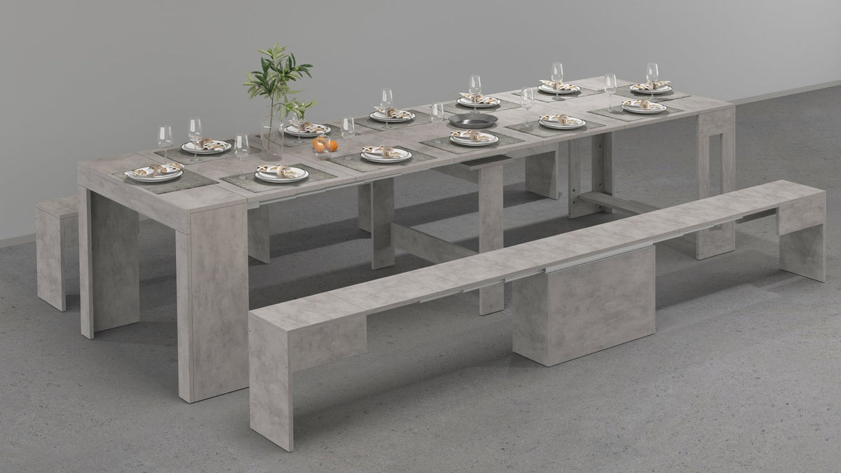 Panca ORION cemento bronx allungata accanto a tavolo apparecchiato con pianta verde #colore_Cemento Bronx