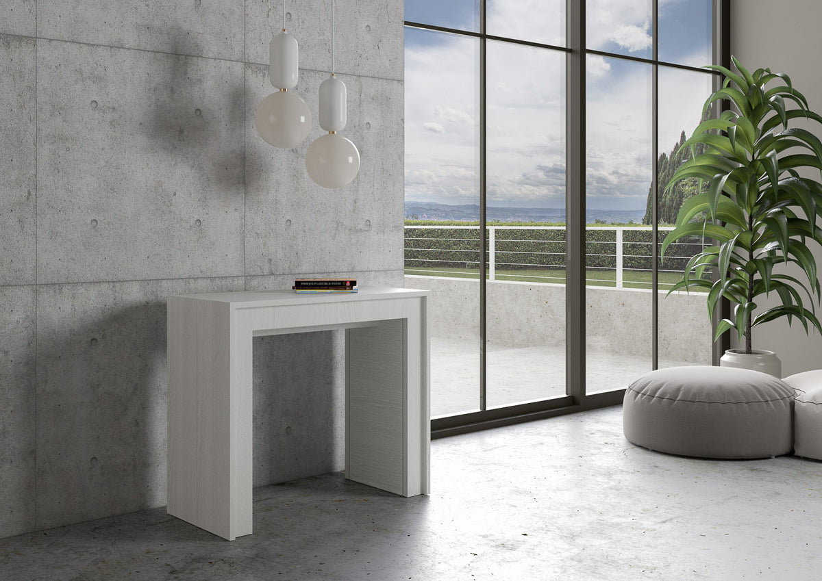 Consolle MIA bianco frassino addossata a una parete di cemento, con due sfere appese sopra #colore_Bianco Frassino
