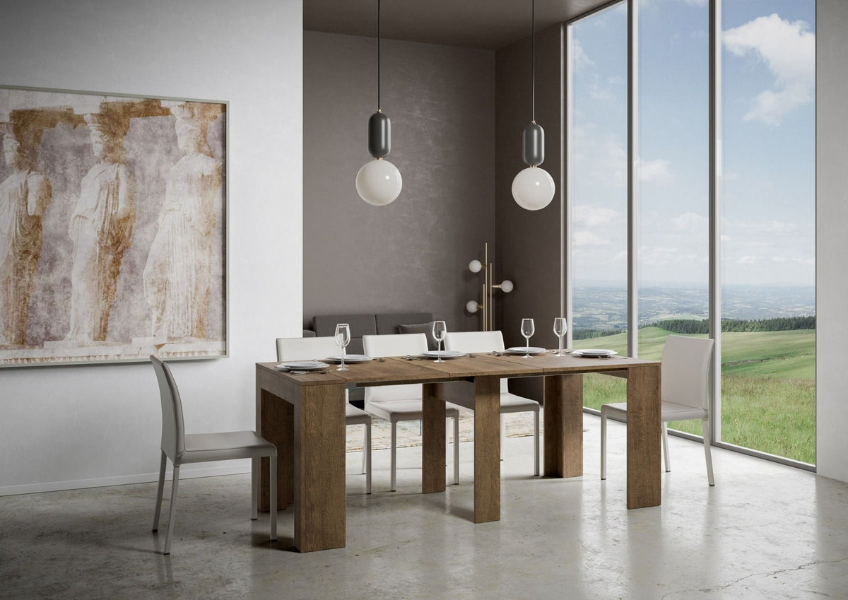 Tavolo MODEM SMALL noce allungato in sala con sei sedie imbottite bianche e lampade sopra #colore_Noce
