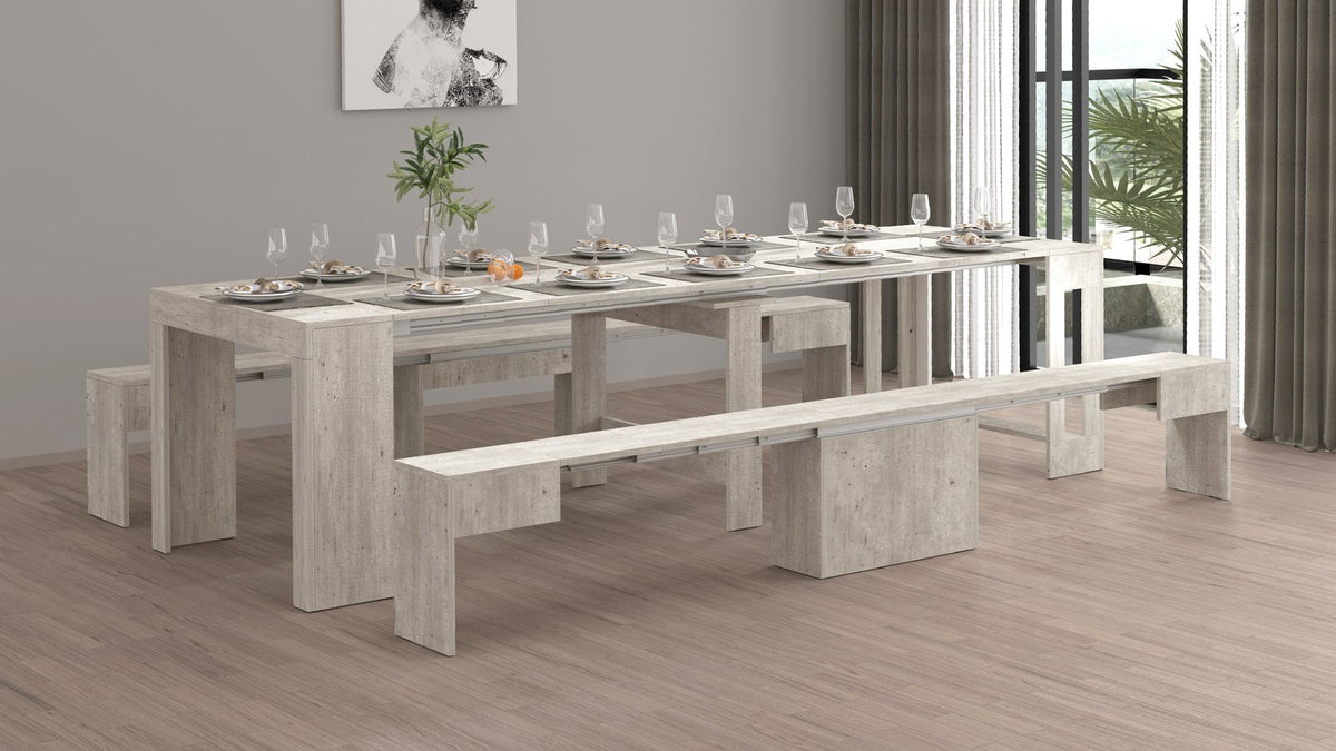 Sala da pranzo con tavolo ORION cemento apparecchiato e panca in primo piano #colore_Cemento