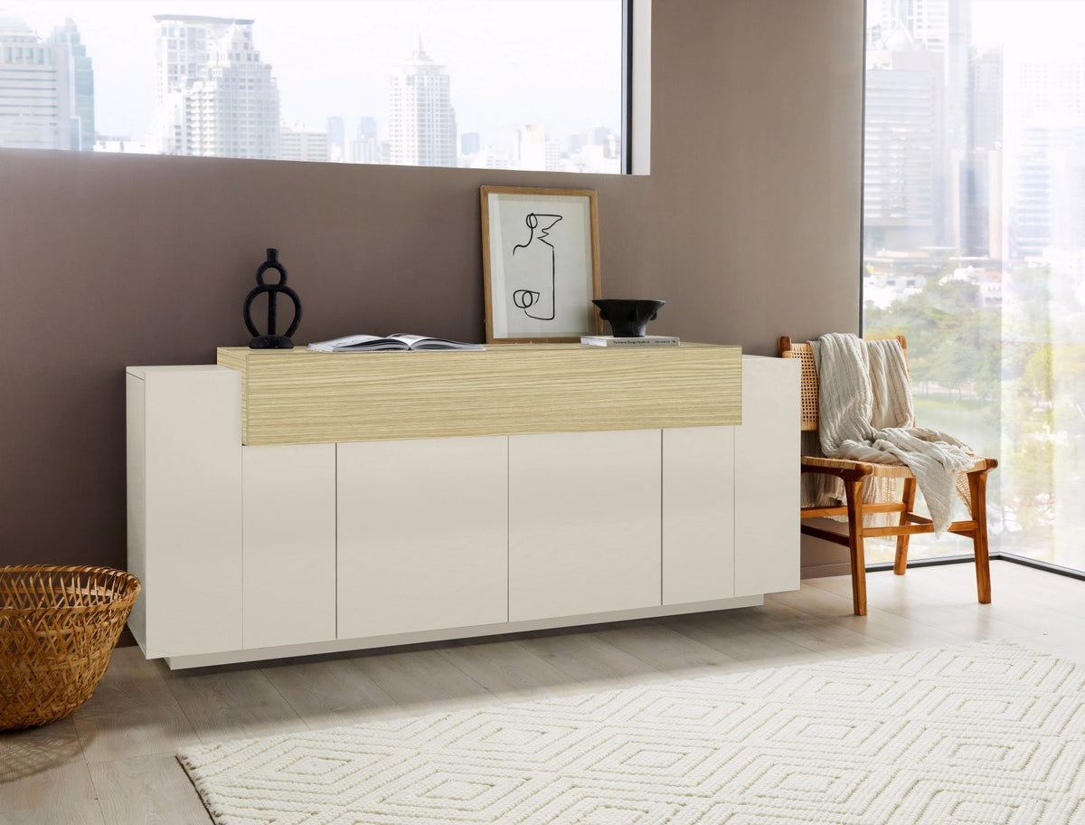 Credenza CELESTIA cashmere in un interno luminoso con finestra, vista tre quarti della fascia in legno #colore_Cashmere