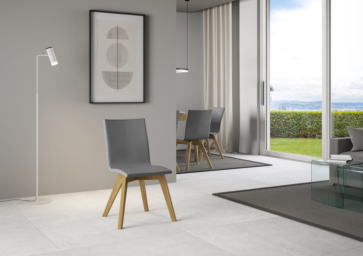 Sedia TRUDY grigia con gambe in legno chiaro di tre quarti in ambiente interno #colore_Grigio